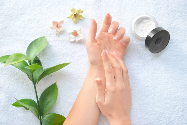 Young woman applying hand cream onto her skin, top view — Stock Photo, Image