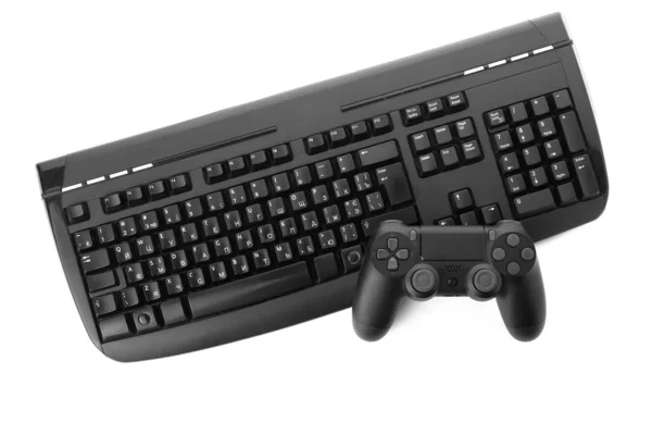 Modern game pad and PC keyboard on white background