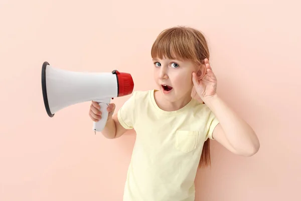 Cute little girl with megaphone trying to hear something on color background — Stock Photo, Image