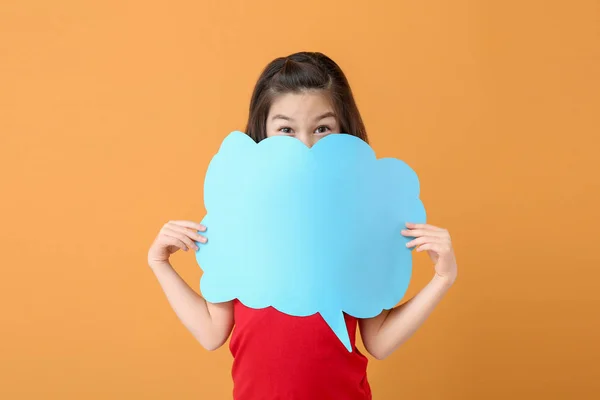 Cute little girl with blank speech bubble on color background — Stock Photo, Image