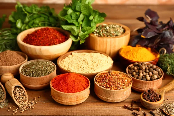 Composition with different spices on wooden background — Stock Photo, Image