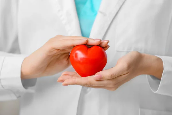 Female cardiologist with red heart, closeup — Stock Photo, Image