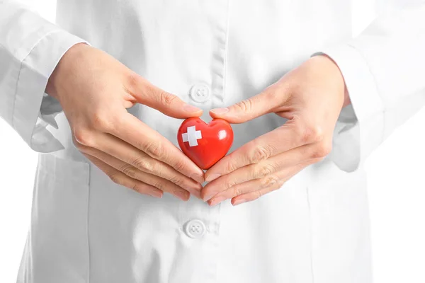 Female cardiologist with red heart on white background, closeup — Stock Photo, Image