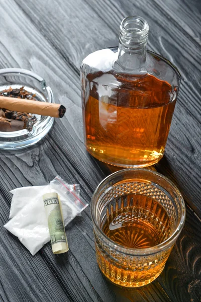 Alcohol, cigar, drugs and money on table. Concept of bad habits — Stock Photo, Image