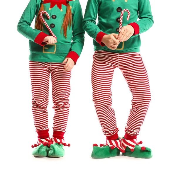 Little children in costume of elf and with candy canes on white background — Stock Photo, Image
