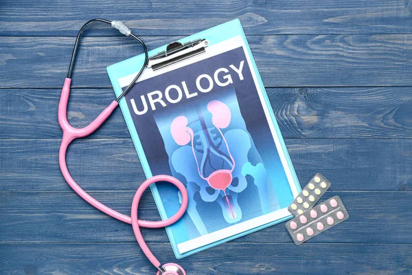 Papier blad met foto van urogenitale systeem, medicijnen en stethoscoop op houten achtergrond — Stockfoto