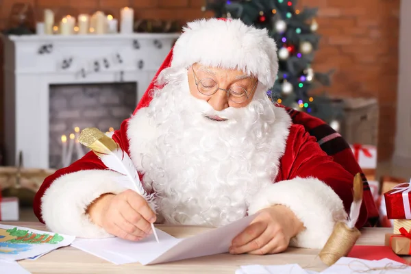 Санта-Клаус составил список подарков в комнате, украшенной к Рождеству — стоковое фото