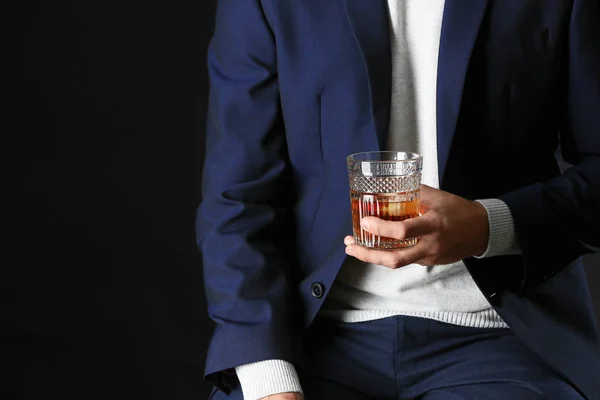 Man in stylish blue clothes and with alcohol on dark background — Stock Photo, Image