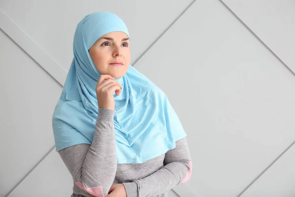 Portrait of beautiful Muslim woman on grey background — Stock Photo, Image