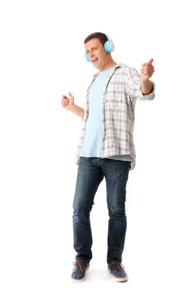 Portrait of happy man listening to music on white background — 스톡 사진