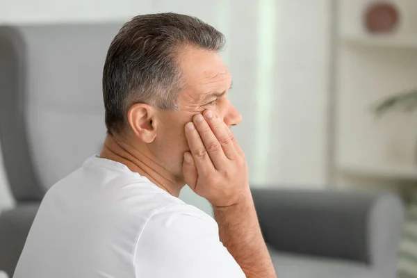 Mature man suffering from tooth pain at home — Stock Photo, Image