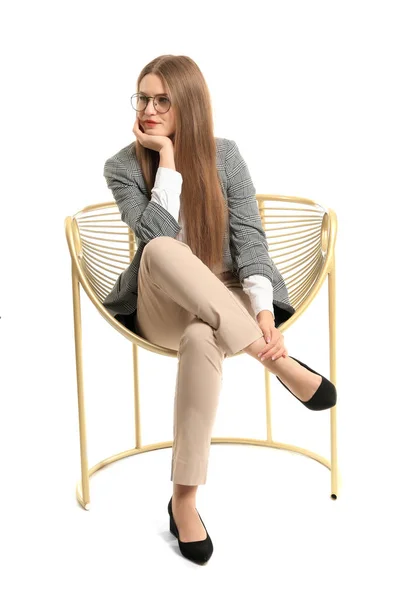 Beautiful businesswoman sitting in armchair on white background — Stockfoto