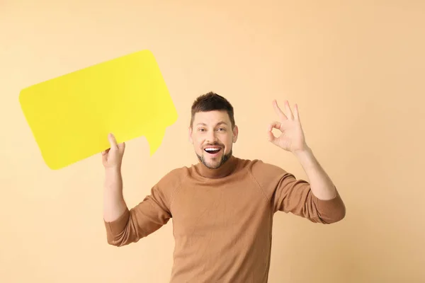 Man with blank speech bubble showing OK on color background — Stock Photo, Image