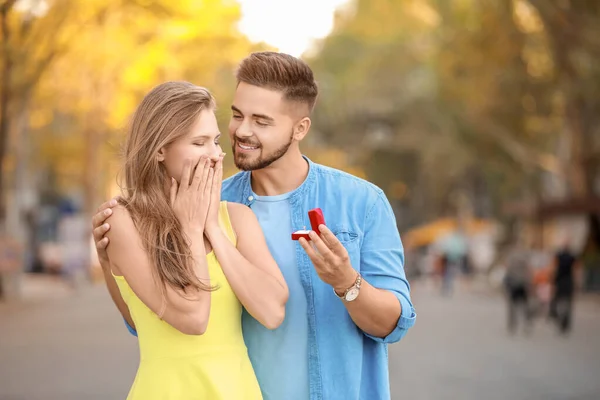 Young man proposing to his beloved outdoors — Stock Photo, Image