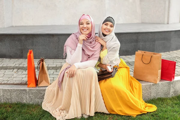 Beautiful Muslim women with shopping bags outdoors — 스톡 사진