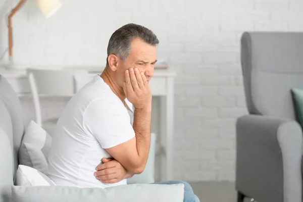 Mature man suffering from tooth pain at home — Stock Photo, Image
