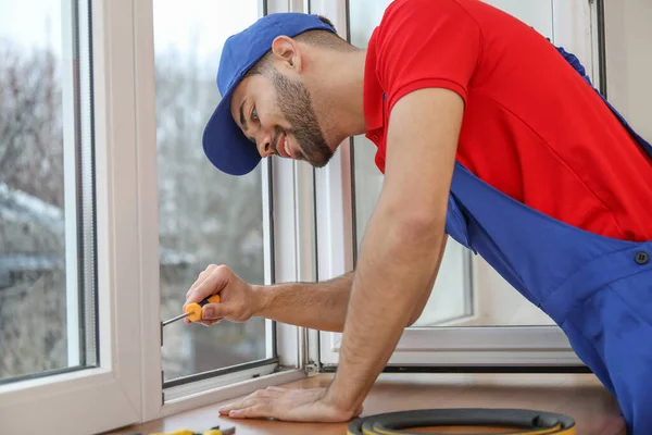 Young worker installing window in flat — Stock Photo, Image