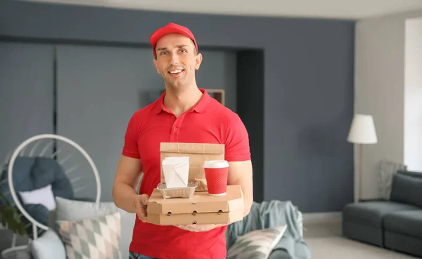 Handsome worker of food delivery service indoors — Stock Photo, Image