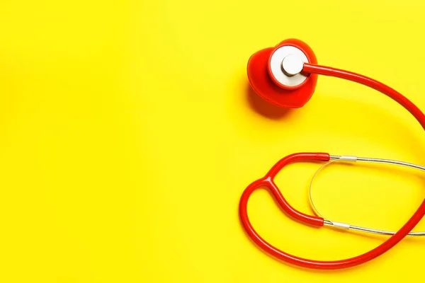 Modern stethoscope and heart on color background — Stock Photo, Image