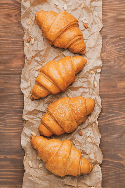 Tasty croissants on wooden table