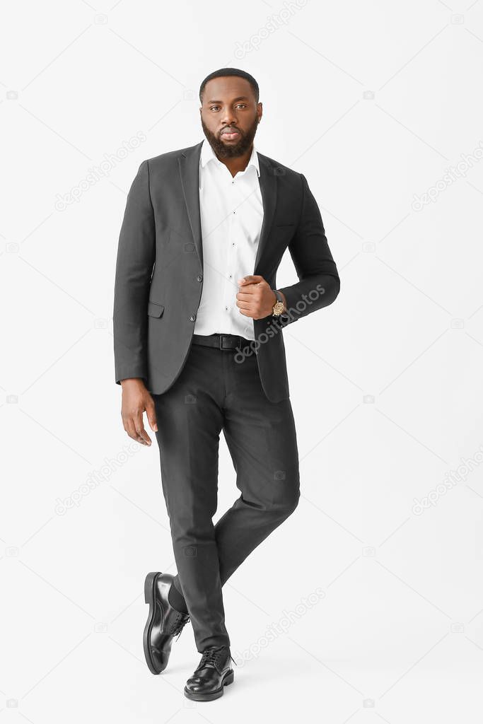 Stylish African-American man on white background