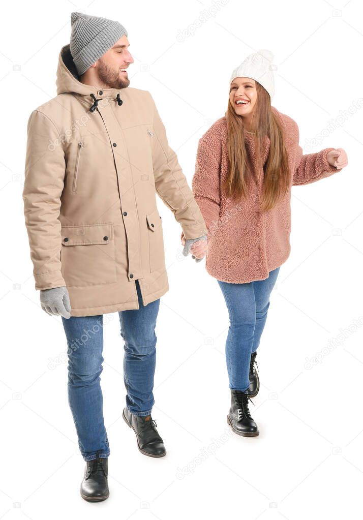 Portrait of happy couple in winter clothes on white background