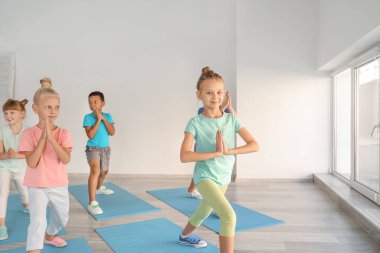 Küçük çocuklar spor salonunda Yoga uygulamak