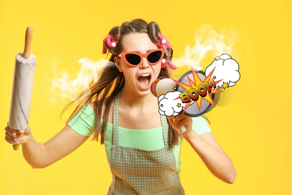 Funny housewife with steam coming out of ears, rolling pin and megaphone on color background — Stock Photo, Image