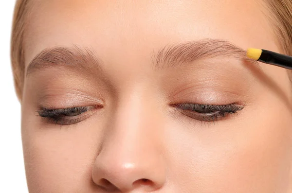 Young woman correcting shape of her eyebrows, closeup — Stock Photo, Image