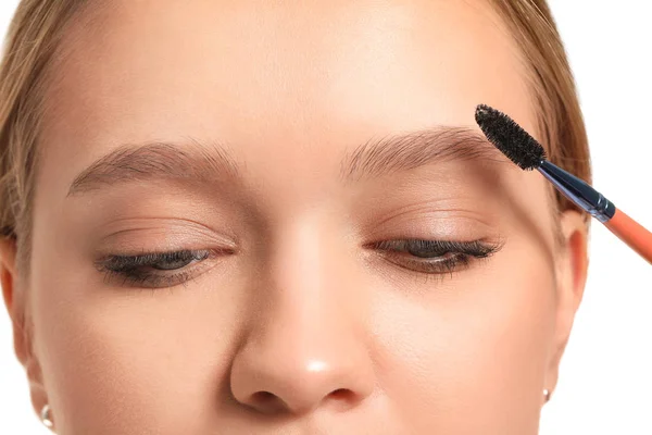 Young woman correcting shape of her eyebrows, closeup — 스톡 사진