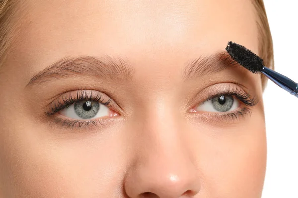 Young woman correcting shape of her eyebrows, closeup — 스톡 사진