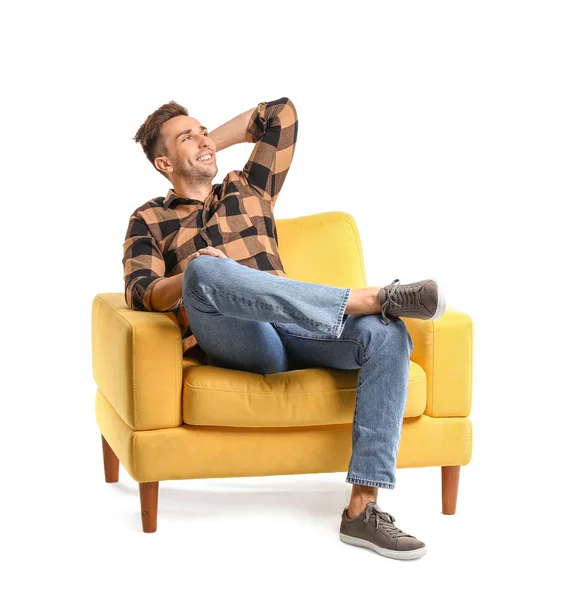 Knappe man zittend in fauteuil op witte achtergrond — Stockfoto