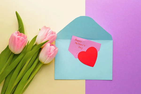 Greeting card and flowers for Mother's Day on color background — Stock Photo, Image