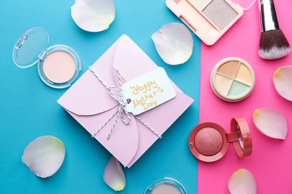 Gift for Mother's Day with makeup cosmetics on color background — Stock Photo, Image