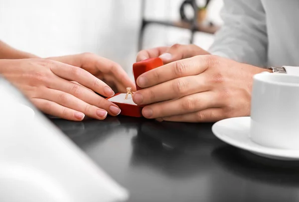 Young man proposing to his beloved on romantic date, closeup — Stock Photo, Image