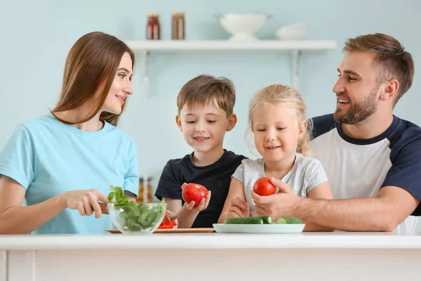 Happy family cooking together in kitchen — Stock Photo, Image