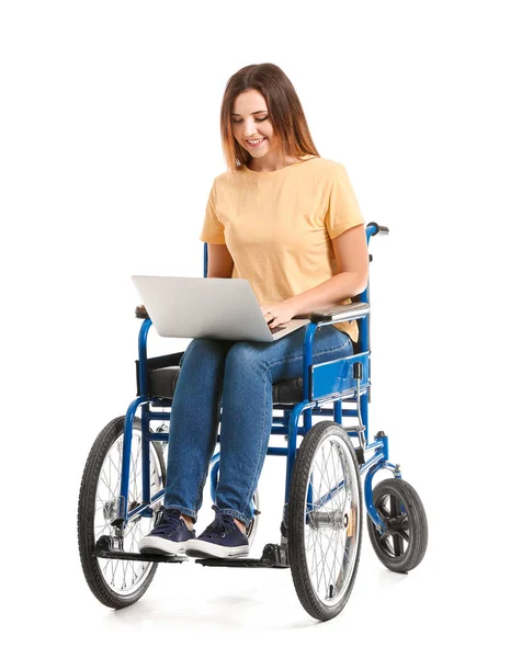 Young woman in wheelchair and with laptop on white background — Stock Photo, Image