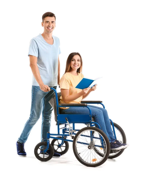 Handicapped young woman in wheelchair and her husband on white background — Stock Photo, Image