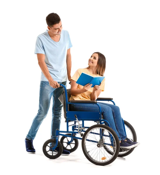 Mujer joven discapacitada en silla de ruedas y su marido sobre fondo blanco — Foto de Stock