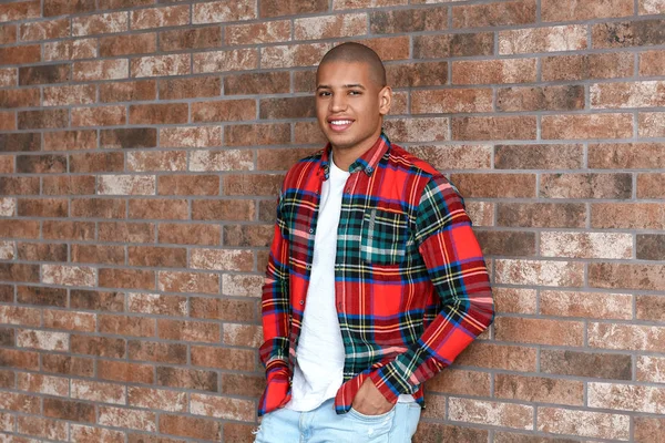 Stylish African-American man near brick wall — Stock Photo, Image