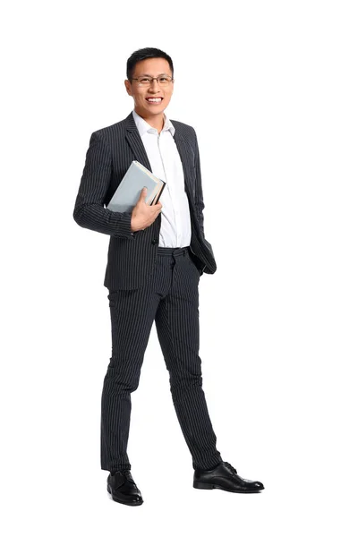 Handsome Asian businessman with books on white background — Stock Photo, Image