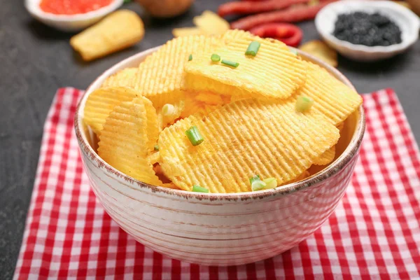 Tigela com saborosas batatas fritas na mesa — Fotografia de Stock
