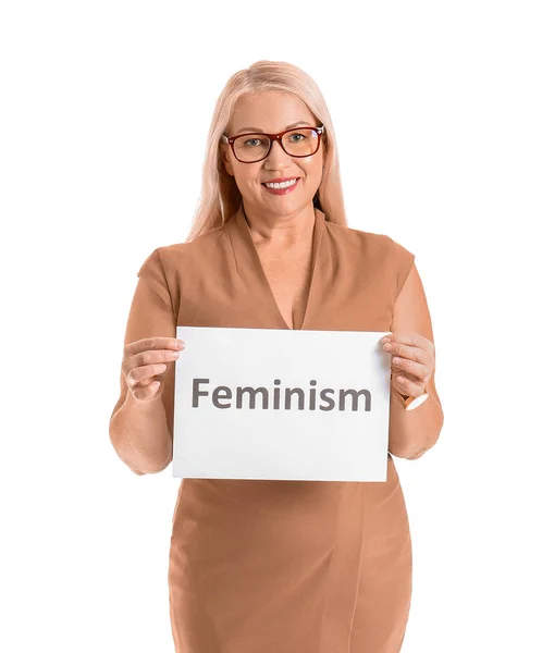 Woman holding paper with word FEMINISM on white background — Stock Photo, Image