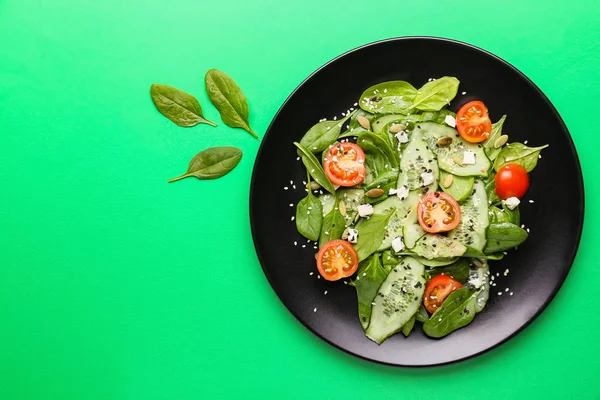 stock image Plate with tasty salad on color background