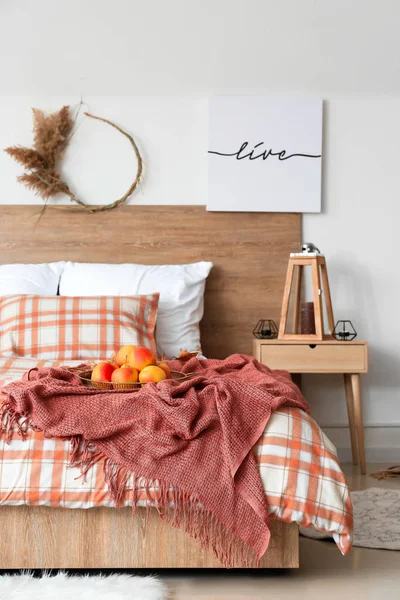 Stylish interior of room with big comfortable bed and autumn decor — Stock Photo, Image
