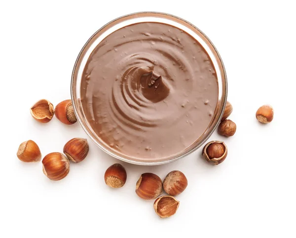 Tasty chocolate paste with hazelnuts on white background — Stock Photo, Image