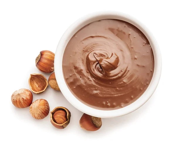 Tasty chocolate paste with hazelnuts on white background — Stock Photo, Image