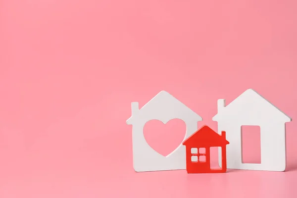 Different figures of houses on color background. Concept of buying real estate — Stock Photo, Image