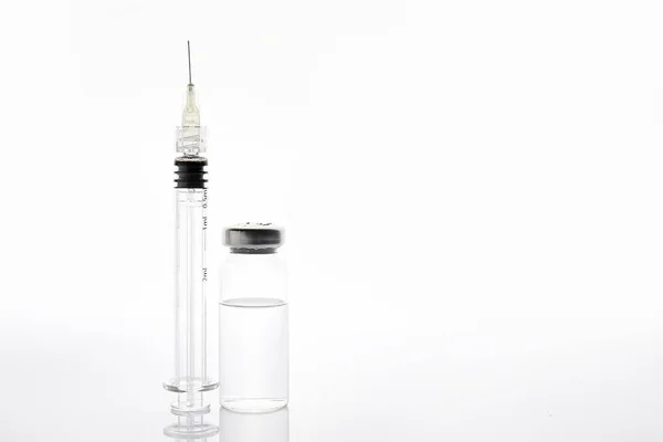 Syringe and ampule with filler for cosmetology on white background — ストック写真