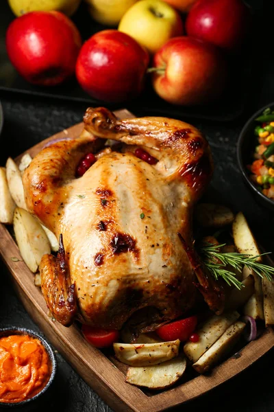 Tasty baked turkey and other dishes for Thanksgiving day on table